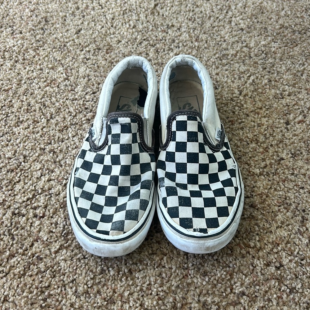 Women’s black and white checkered vans slip on.